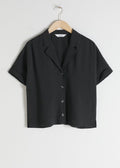 short sleeve black button top